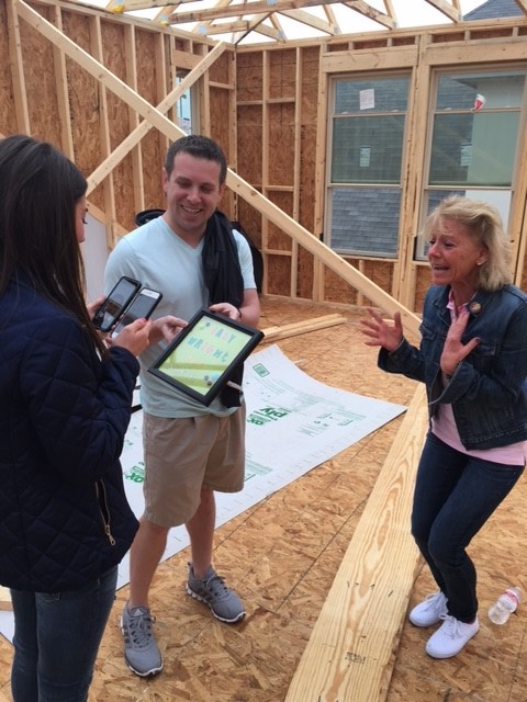 Couple makes new home announcement and baby announcement in new home being built.
