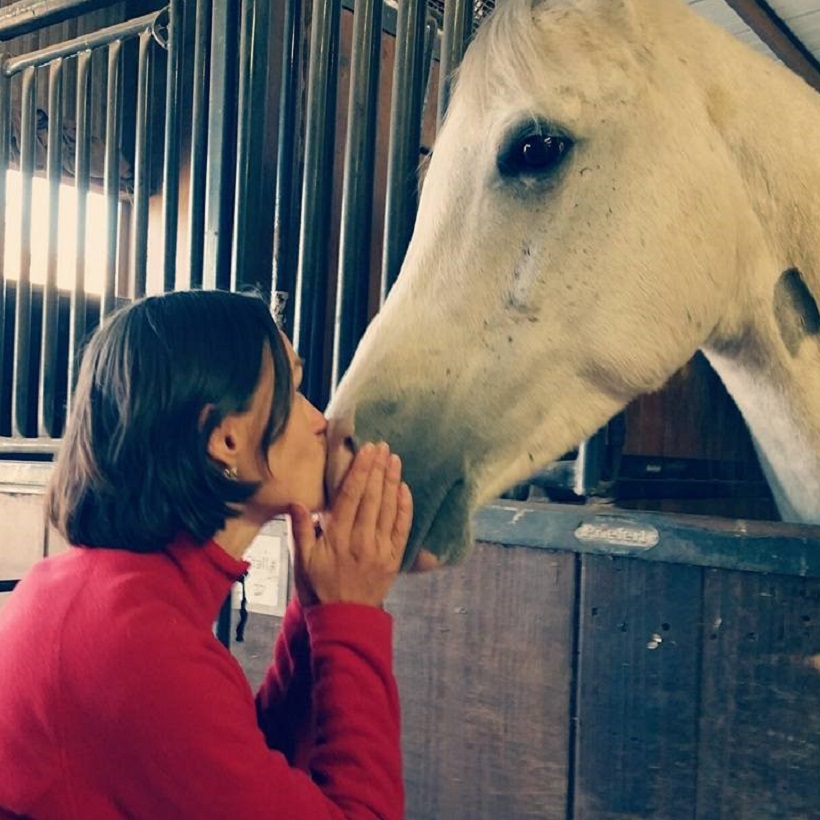 Woman kissing horse as a Hope, Healing and Hooves representation