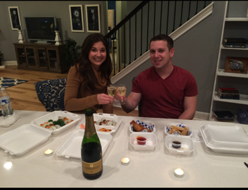 New homeowners enjoying dinner in a model home.