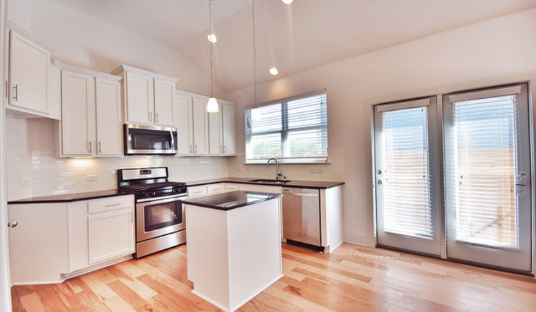 A spacious floor plan with an open kitchen.