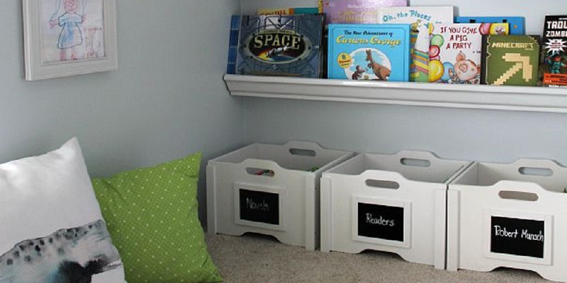 Organized toy bins and shelves for books in a back-to-school-ready home.