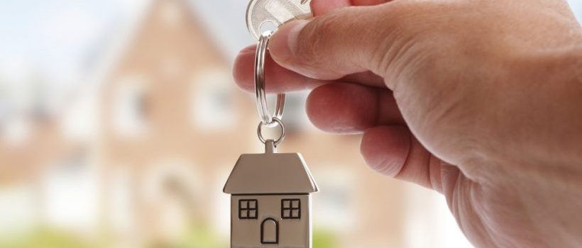 homeowner holding keys to new home after following MileStone’s home buying guide.