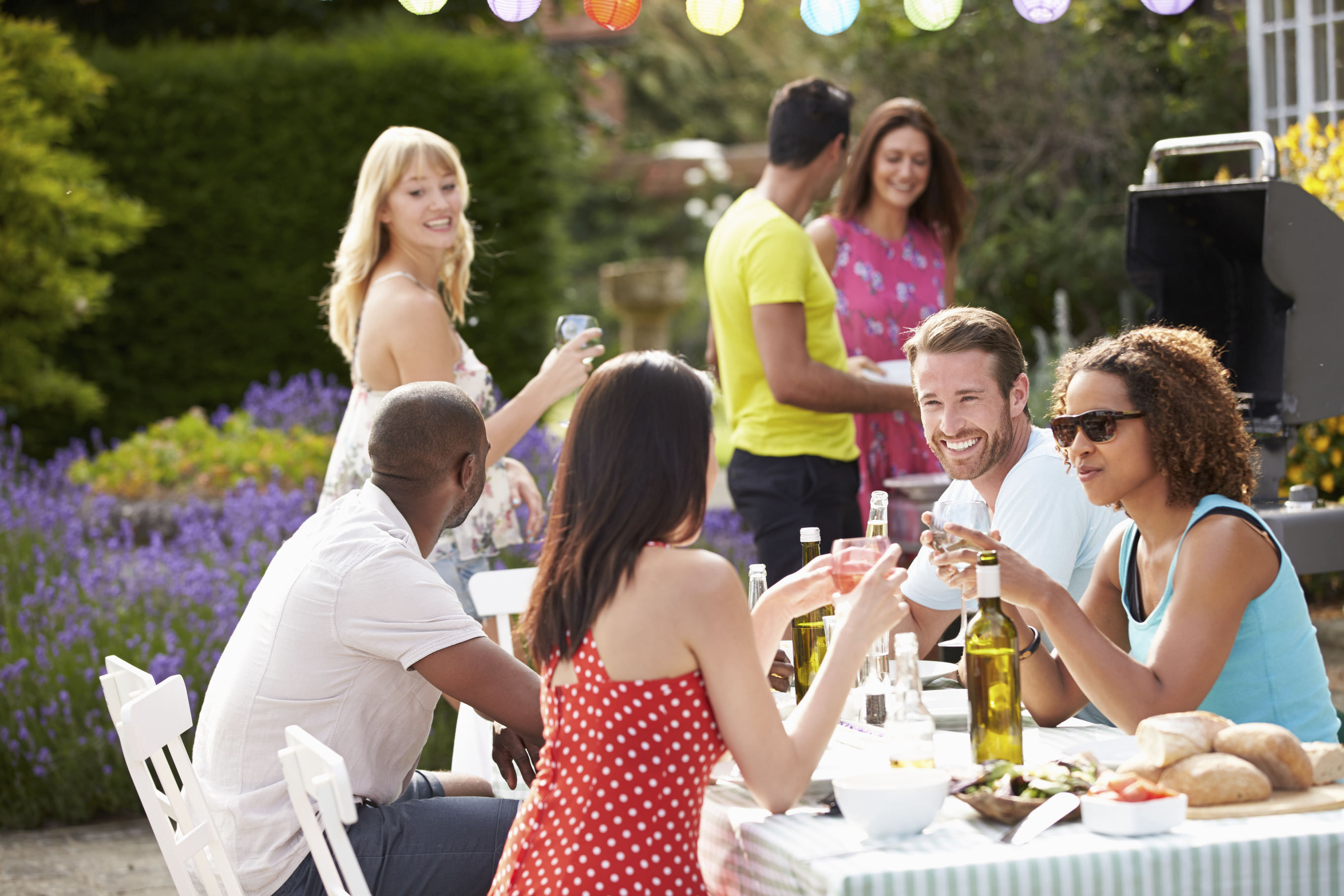 Group Of Friends Having Outdoor Barbeque At Home - Austin Homes for ...