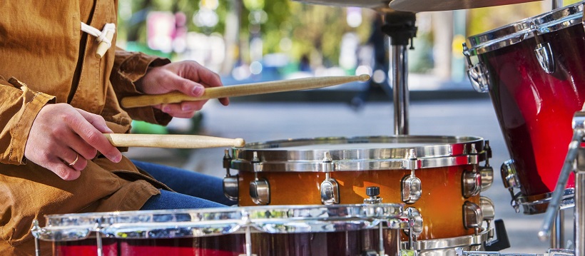 Man playing drums along Austin, Texas streets.