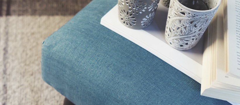 Blue cushion under book and cups as an autumn accent.