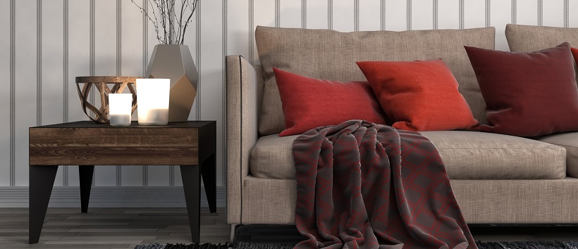 Shades of red pillows pose as autumn accents in this living room.