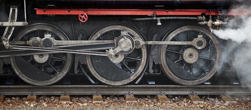 Close-up view of steam train wheels