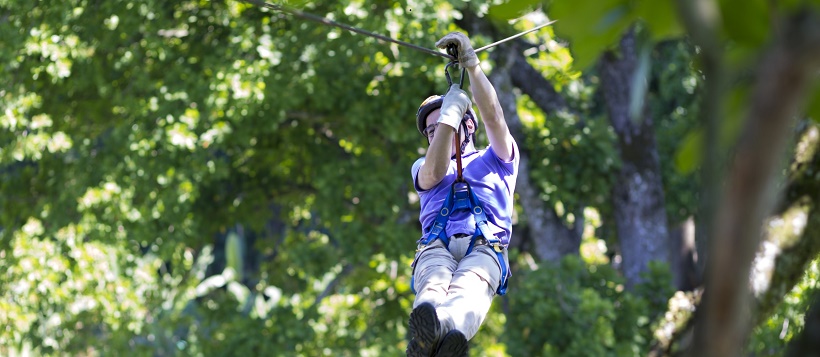 Man zip lining near Lake Travis as one of the things to do in Cedar Park