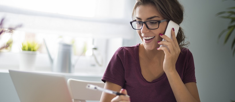 Woman talking on phone to help plan for hosting houseguests