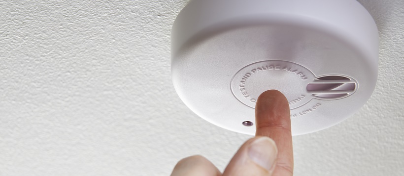 Person checking smoke detector