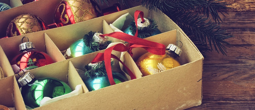 Christmas ornaments organized into a cardboard box