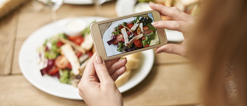 Girl taking a picture of her food