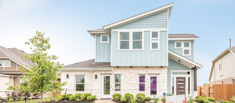 Modern exterior of a new Austin home with blue paneling and stone materials