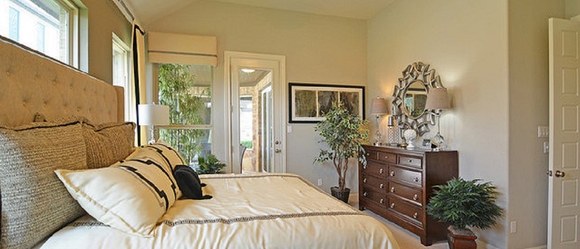 White bedroom surrounded by windows in a new Austin home