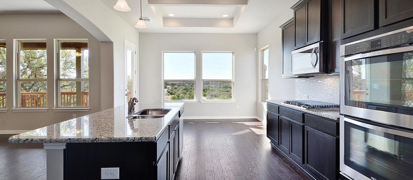 Cedar Park home with a contemporary kitchen opening up to a great Hill Country view.