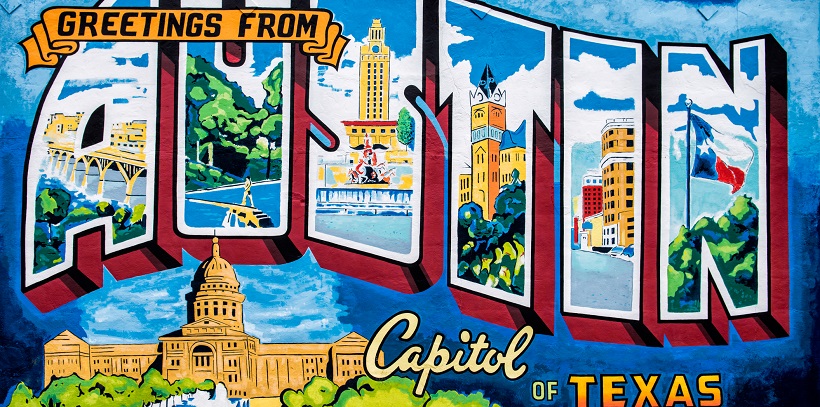 Colorful mural reading ‘Greetings from Austin Capitol of Texas’ for a moving announcement picture.