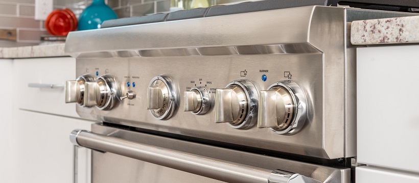 Close up of modern stainless steel oven to answer why buy new homes question.