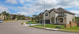 Street view of two-story suburban homes in a neighborhood.