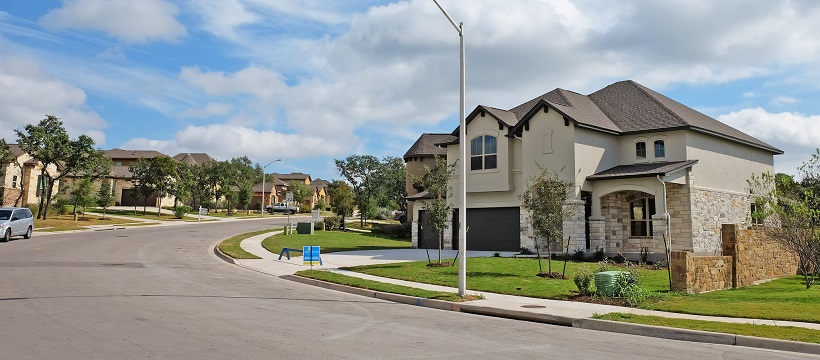 Street view of two-story suburban homes in a neighborhood.