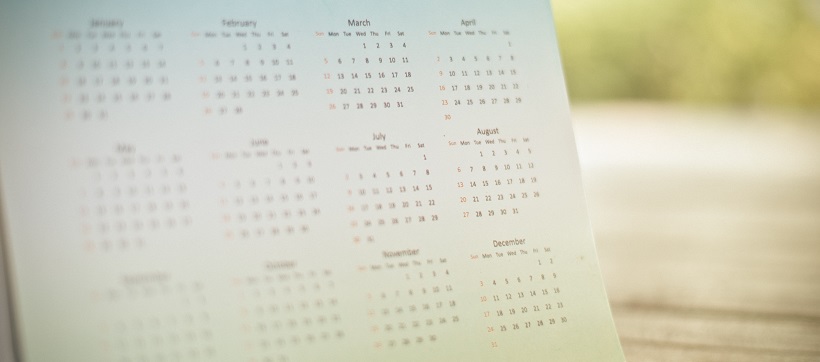 Faded image of a calendar showing each month of the year.