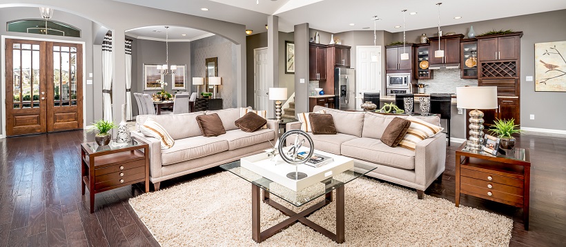 Living room opens up to dining room and kitchen area to show an example of open-concept homes.