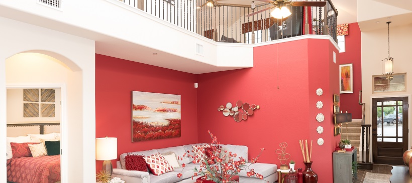 Fuchsia accent wall shows off a vibrant living room of an open-concept home.