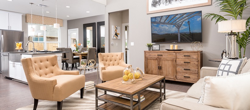 Living room with contemporary furniture with kitchen and dining room in the background.