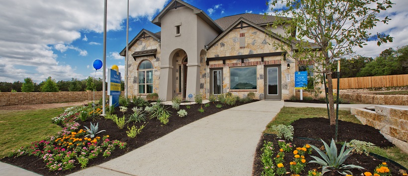 Beautiful front exterior of a landscaped front yard that leads up to two-story home.