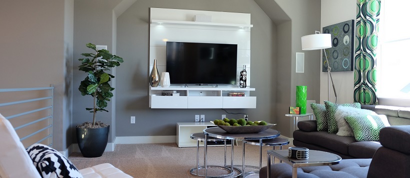 Media room with gray walls and a white modern decor piece surrounding the television.