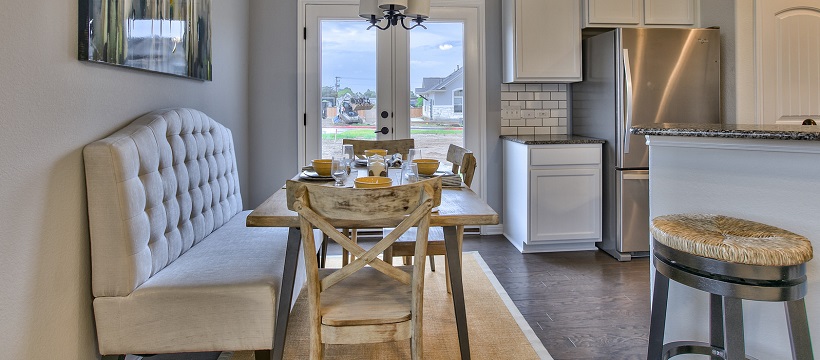 Rustic breakfast area with French doors in the background and near a white kitchen.