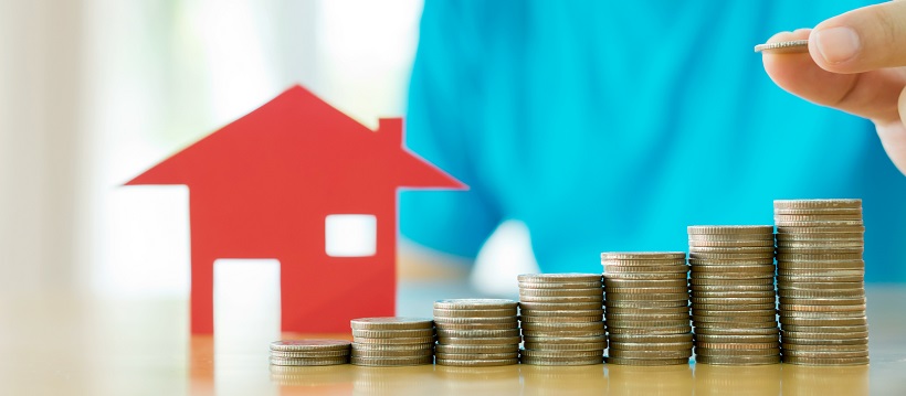 Paper cutout of a house with stacks of coins that get taller the farther to the left they stand.