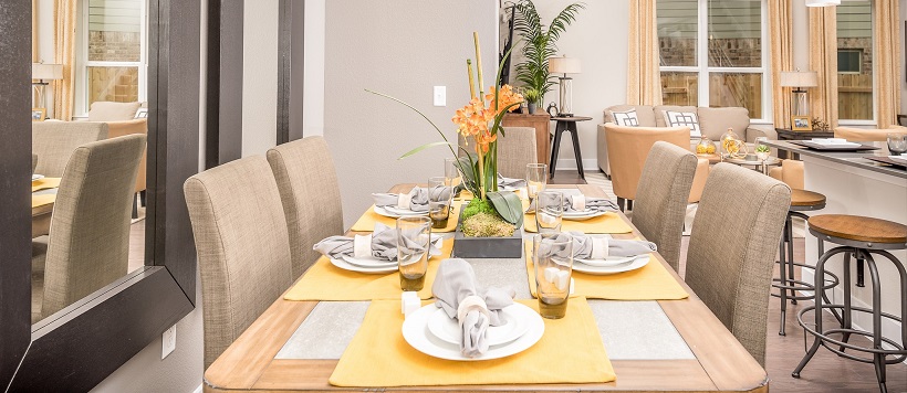 Dining room with fall paint colors and yellow placemats on a dining table.