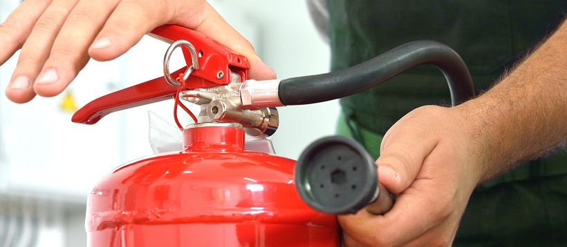 Worker Demonstrates the use of fire extinguishers.