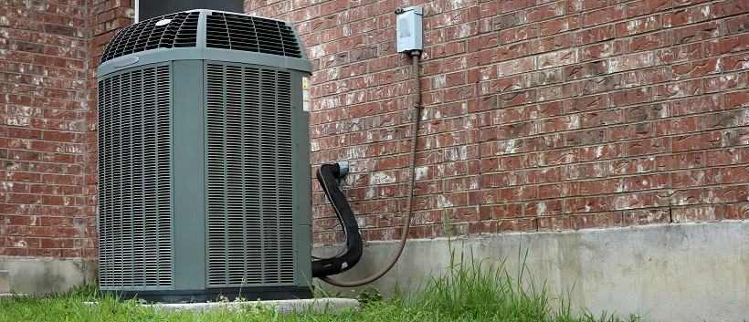 View of the side of a house and an HVAC system to represent the question “How long do appliances last?”