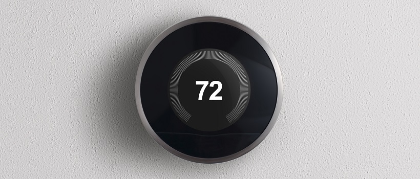 A black Nest Thermostat reads a temperature of 72 degrees Fahrenheit.