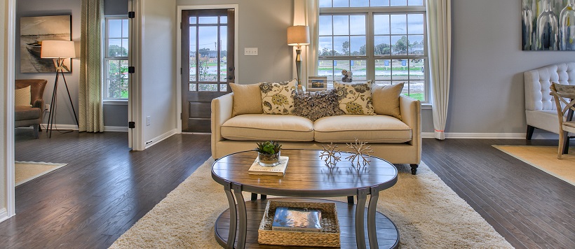 An open-concept living room leads into a nearby study area and a dining room.