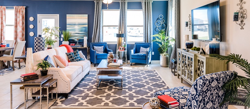 A bright blue accent wall showcases an open-concept living room of one of the best Austin, Texas, quick delivery homes.