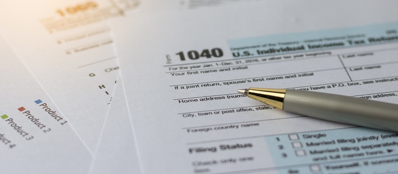 A pen sitting on U.S. individual income tax return form.