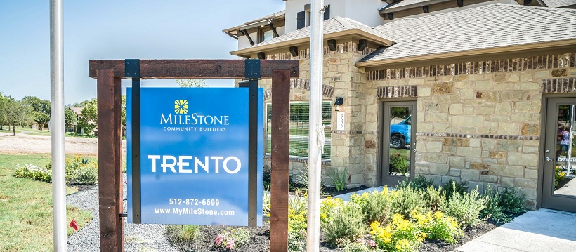 Community sign in front of model home to represent one of the new Cedar Park homes in Trento.