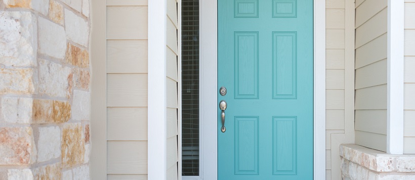 Front porch exterior with stone and siding surrounding a light blue front door to represent some of the best homes around Austin.