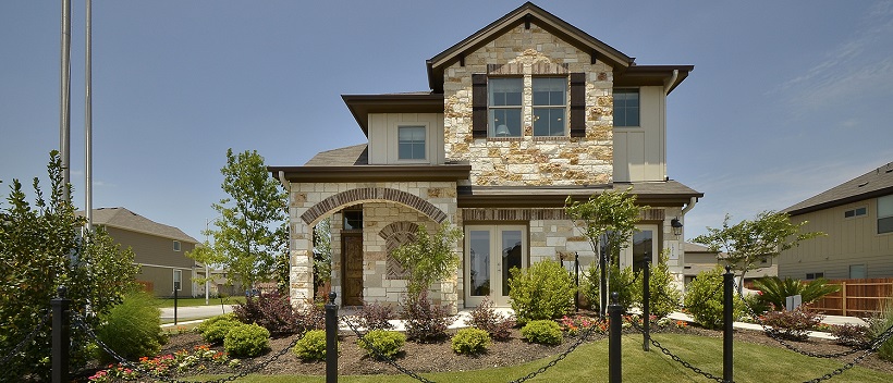 Landscaping surrounds a South Austin home with a gorgeous stone exterior.
